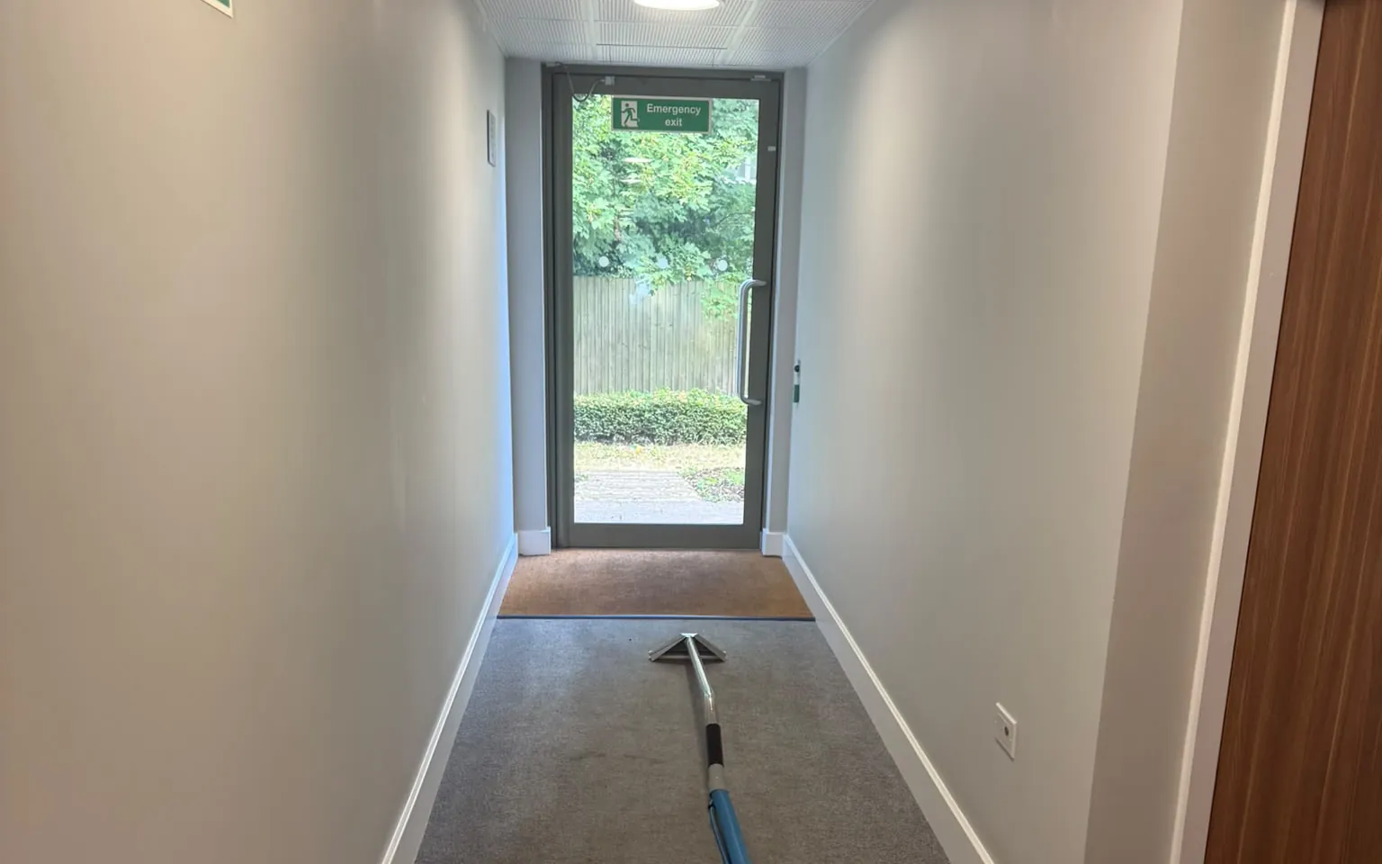 Carpet extraction in progress in a London communal corridor